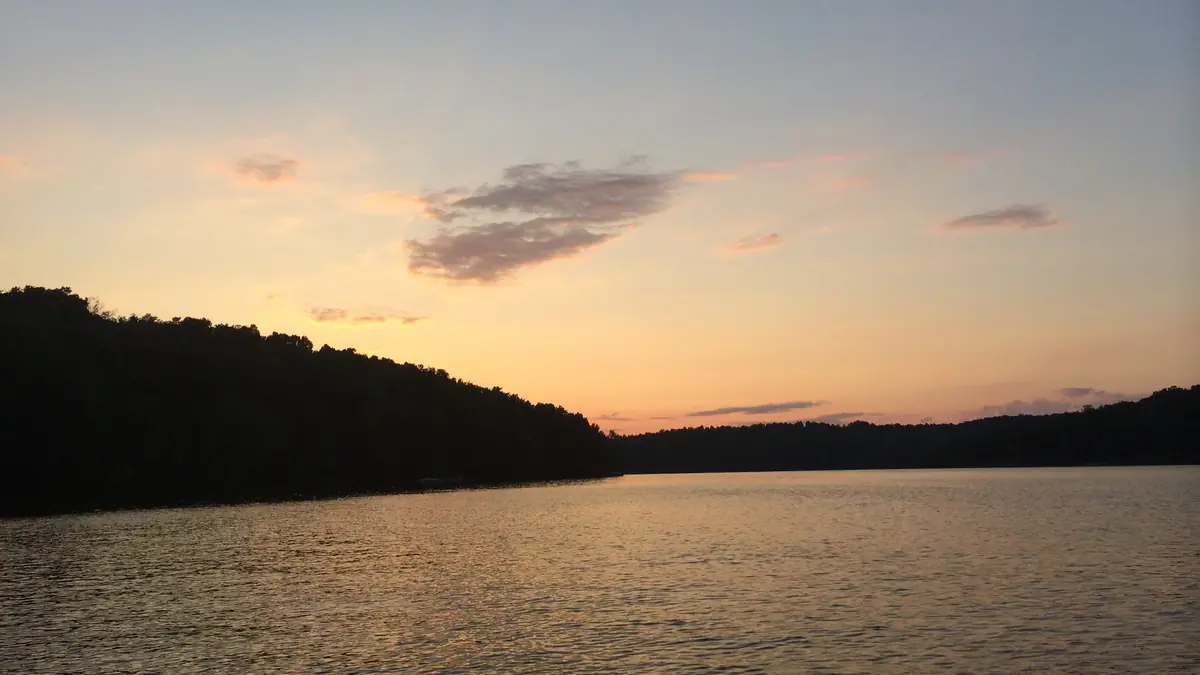 Sunset over Nolin Lake with wooded hills on the far shore, Kentucky